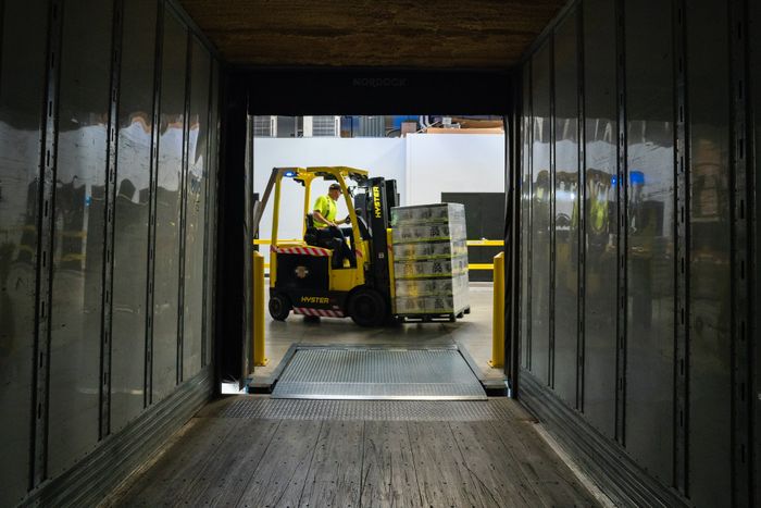 Forklift loading goods into a lorry