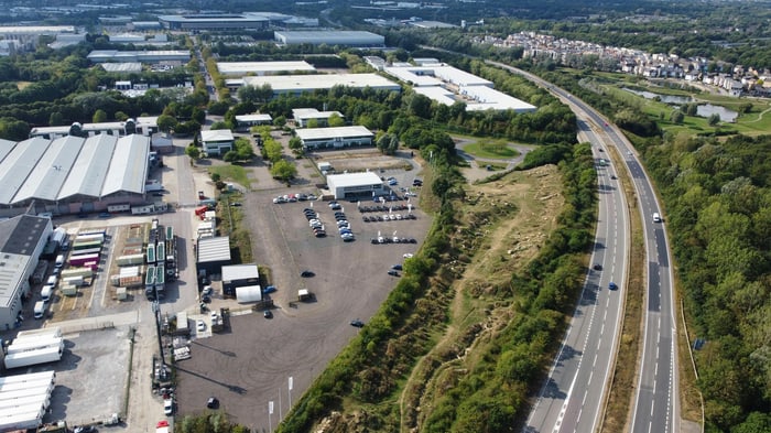 Aerial view of a logistics and industrial estate beside a major road